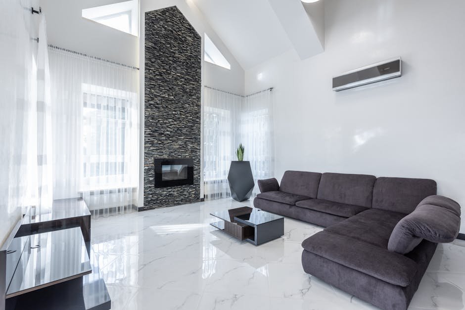 pexels-photo-6283961-6283961 Elegant modern living room featuring a stone fireplace, sleek furniture, and airy ambiance.
